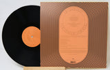 Vinyl record with orange label and black cover on a white background