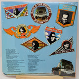 Album cover with various music labels and a truck illustration on a blue background