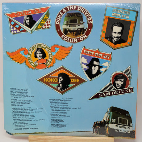 Album cover with various music labels and a truck illustration on a blue background