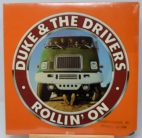 Vinyl record cover for 'Duke & The Drivers Rollin' On' with a green truck on an orange background