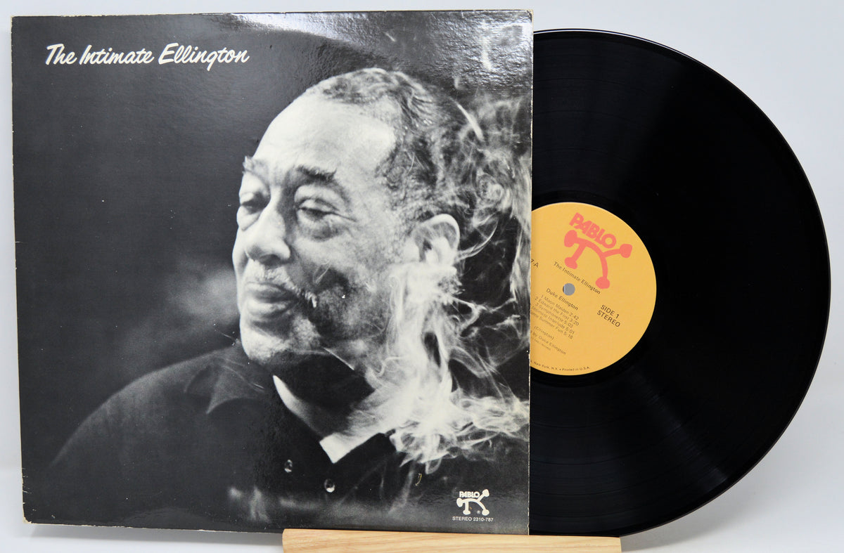 Vinyl record album 'The Intimate Ellington' with the black LP partially pulled from the sleeve, showing a black-and-white portrait on the cover and a yellow label on the record.