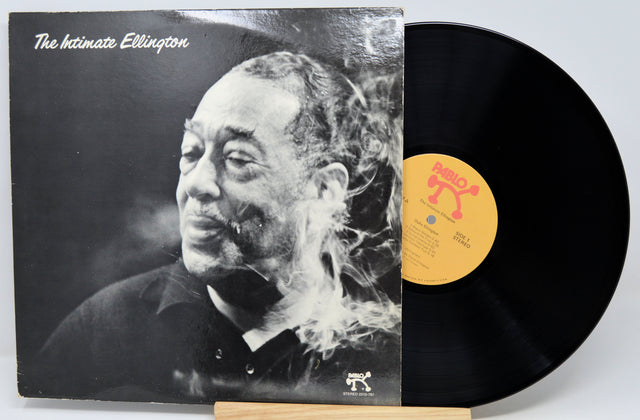 Vinyl record album 'The Intimate Ellington' with the black LP partially pulled from the sleeve, showing a black-and-white portrait on the cover and a yellow label on the record.