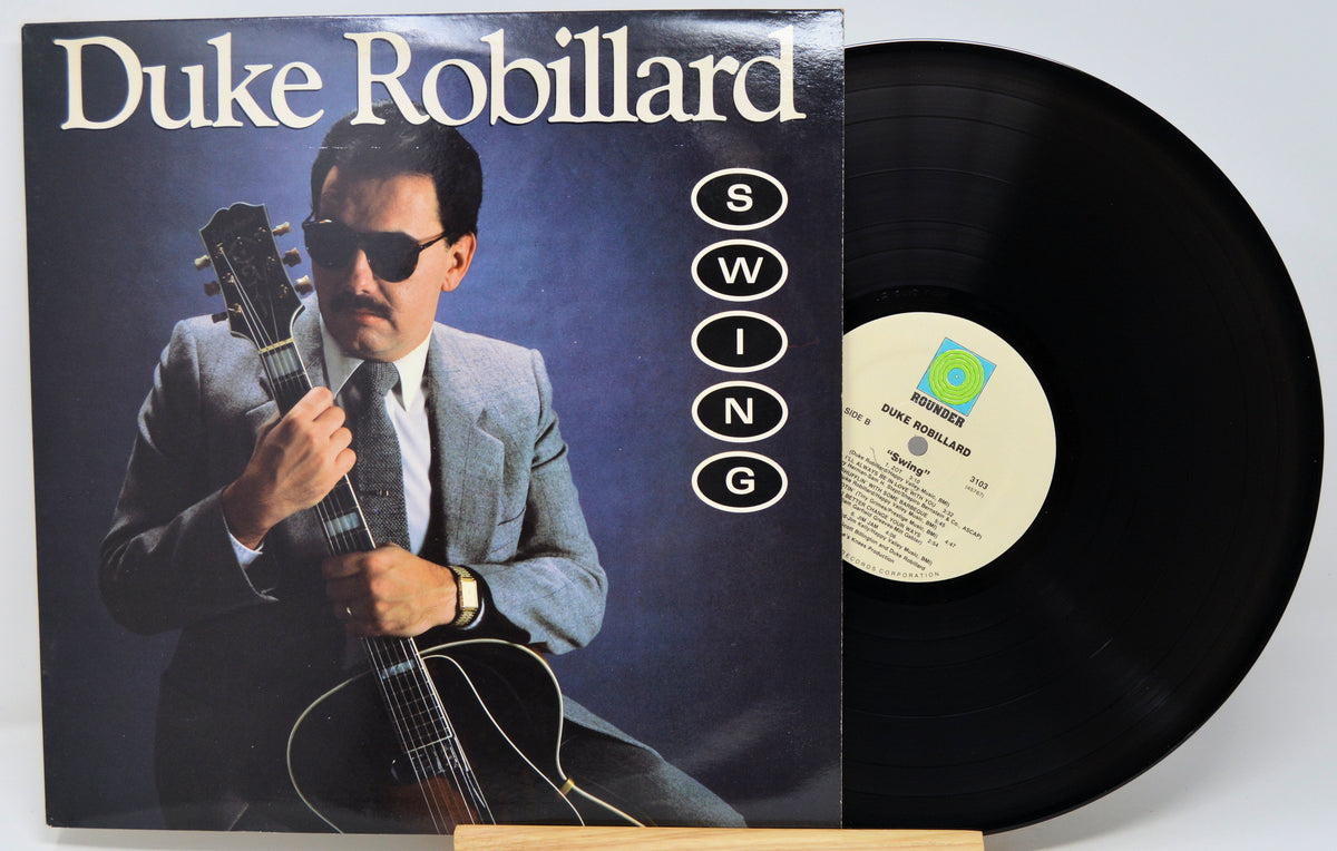 Duke Robillard 'Swing' vinyl record LP with the album cover in front and the black vinyl record partially visible behind it on a light gray background.