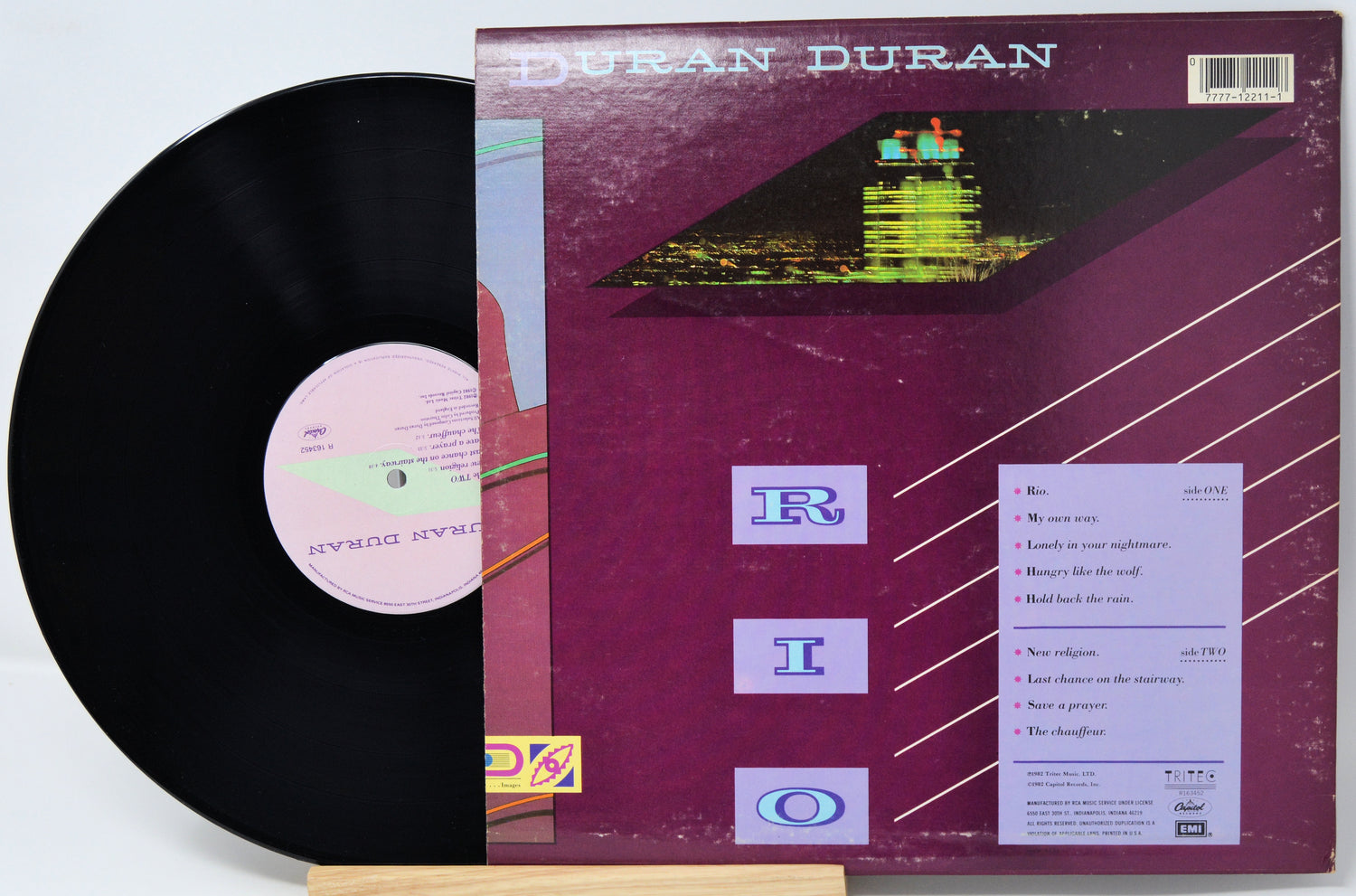 Vinyl record and cover with 'Duran Duran' album art on a white background
