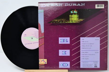 Vinyl record and cover with 'Duran Duran' album art on a white background