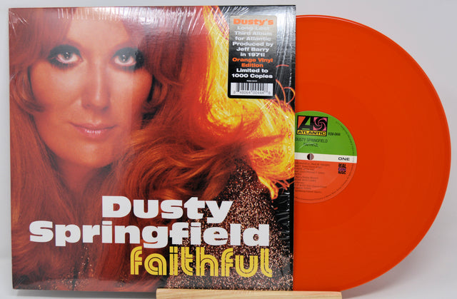 Dusty Springfield's 'Faithful' vinyl record LP with its illustrated cover sleeve and a bright orange translucent record partially visible behind it.