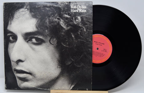 Vinyl record with cover featuring a black and white portrait of Bob Dylan, titled 'Hard Rain'.