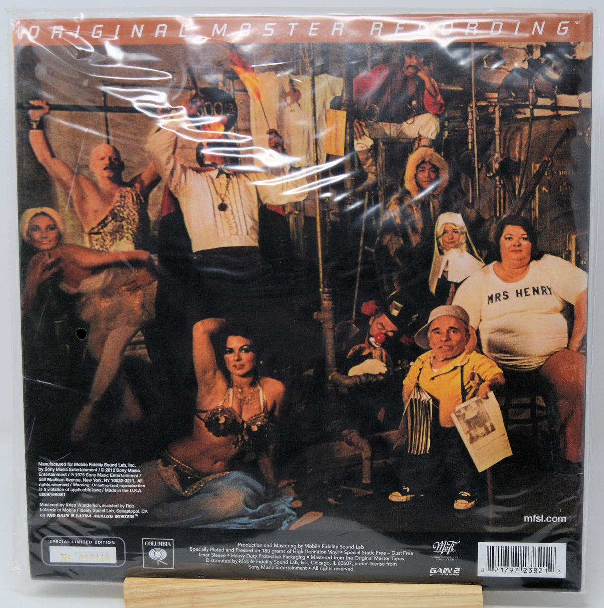 The back cover of the 'Original Master Recording' vinyl LP for Marilyn Manson's album 'The Game', sealed in its plastic shrink-wrap and displayed on a wooden stand.