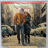 The Freewheelin' Bonzo Dylan vinyl record sleeve, sealed in plastic shrink wrap and displayed on a small wooden stand against a white background.