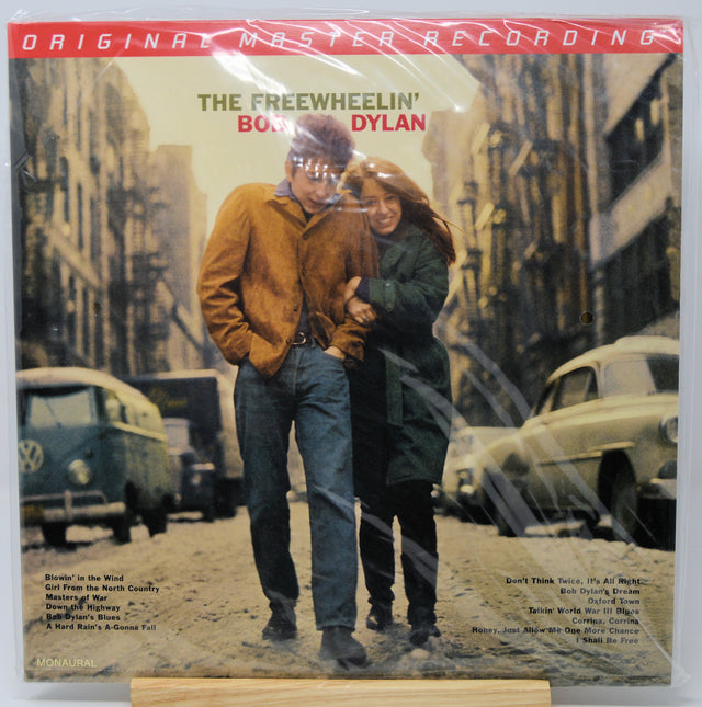 The Freewheelin' Bonzo Dylan vinyl record sleeve, sealed in plastic shrink wrap and displayed on a small wooden stand against a white background.