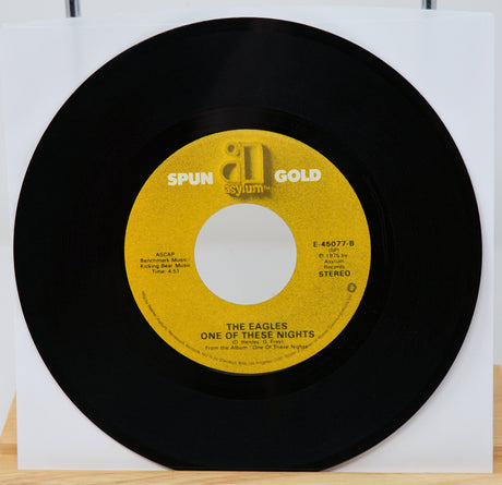 Vinyl record with yellow label featuring 'Spun Gold' and 'Asylum' logos, on a white background.