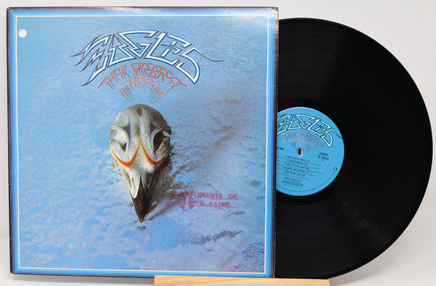 Vinyl record with a blue cover featuring a fish skull illustration and the band's name.