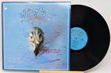 Vinyl record with a blue cover featuring a fish skull illustration and the band's name.