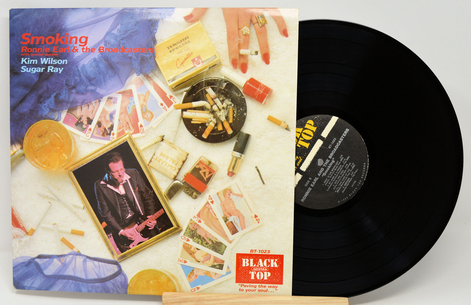 Vinyl record with colorful cover featuring smoking-themed images and a visible label.