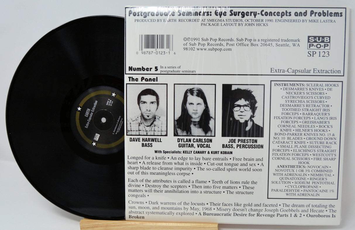 Back cover of Earth’s 'Extra-Capsular Extraction' LP showing band panel, credits, and track details