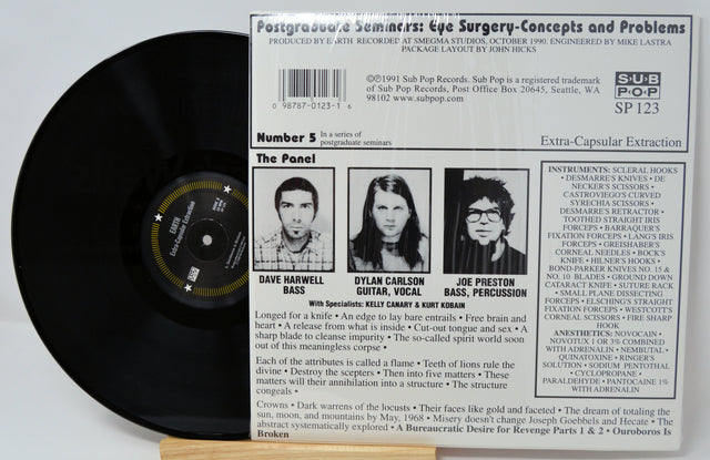 Back cover of Earth’s 'Extra-Capsular Extraction' LP showing band panel, credits, and track details