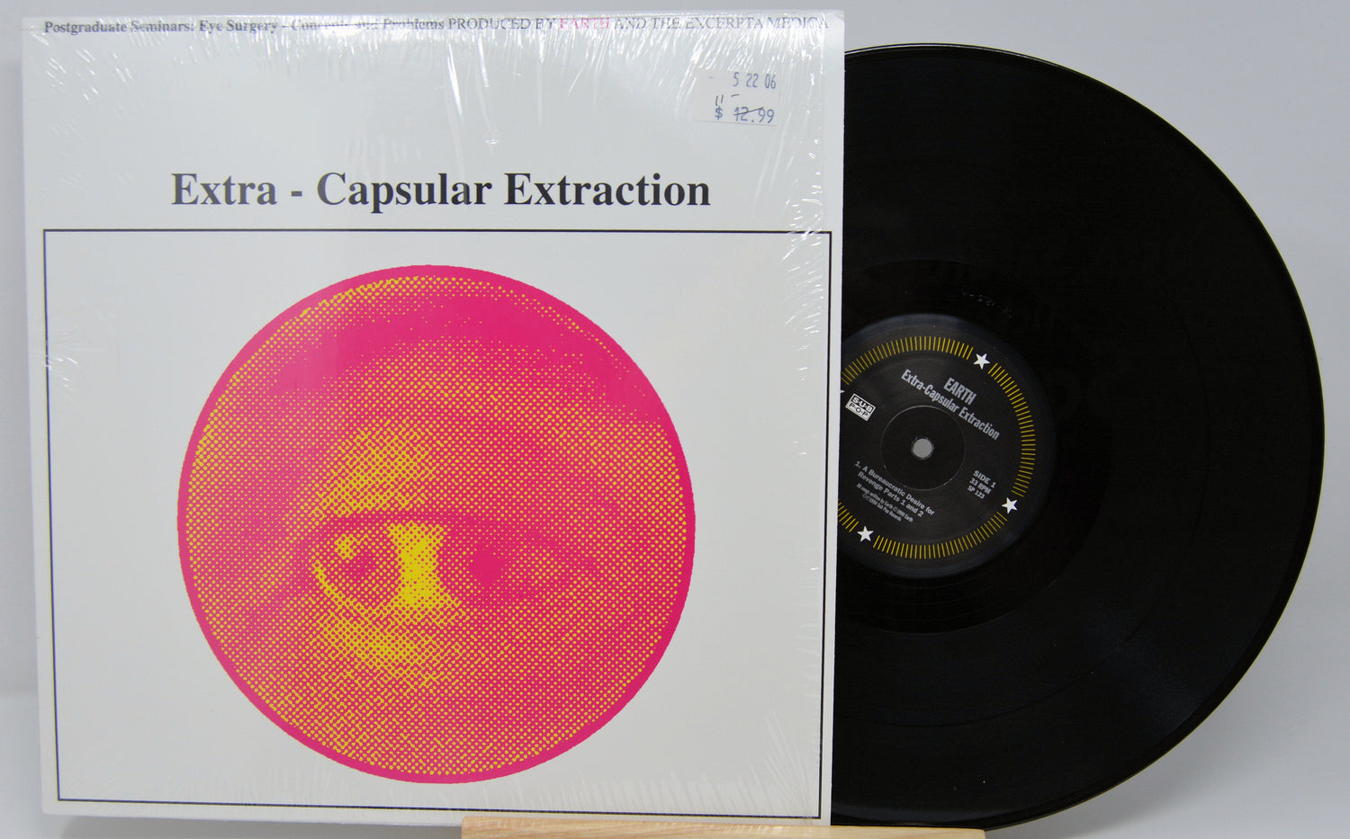 Front cover of Earth’s 'Extra-Capsular Extraction' LP featuring bold pink-yellow abstract eye artwork