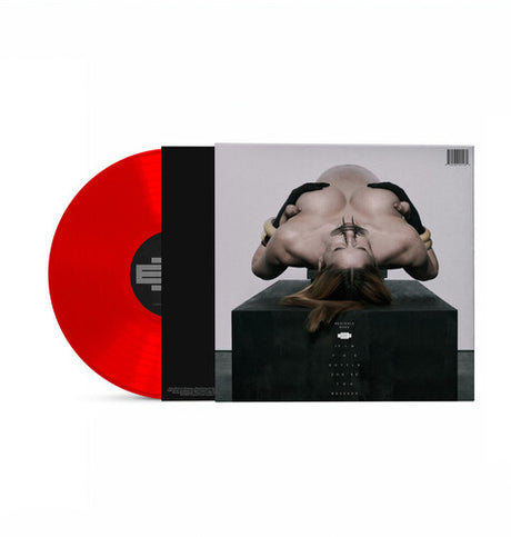 Vinyl record with a red disc and black and white cover featuring a stylized phot of Eartheater lying down with her head is closest to the camera and she is nude with her hands over her nipples.
