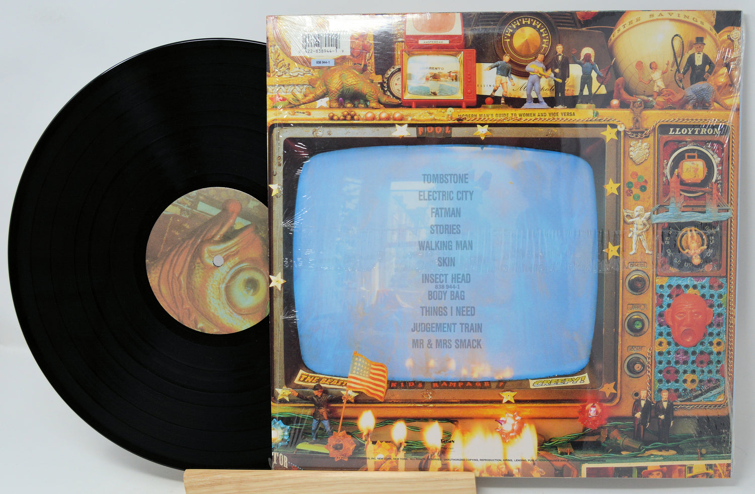 Vinyl record with colorful cover featuring a vintage television design.