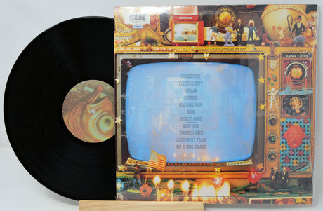 Vinyl record with colorful cover featuring a vintage television design.