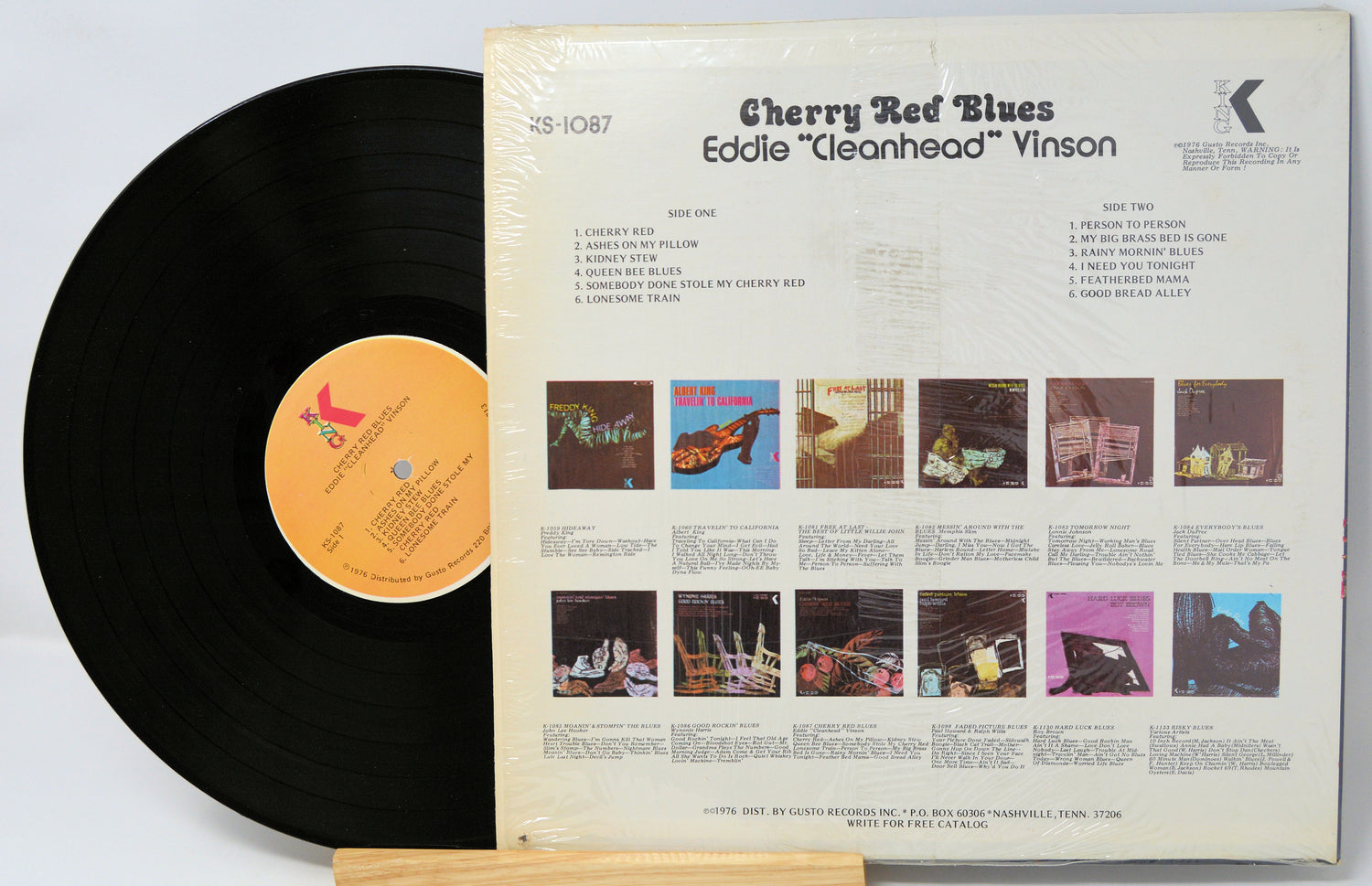 Vinyl record with cover displaying album art and text