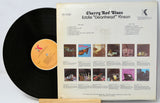 Vinyl record with cover displaying album art and text