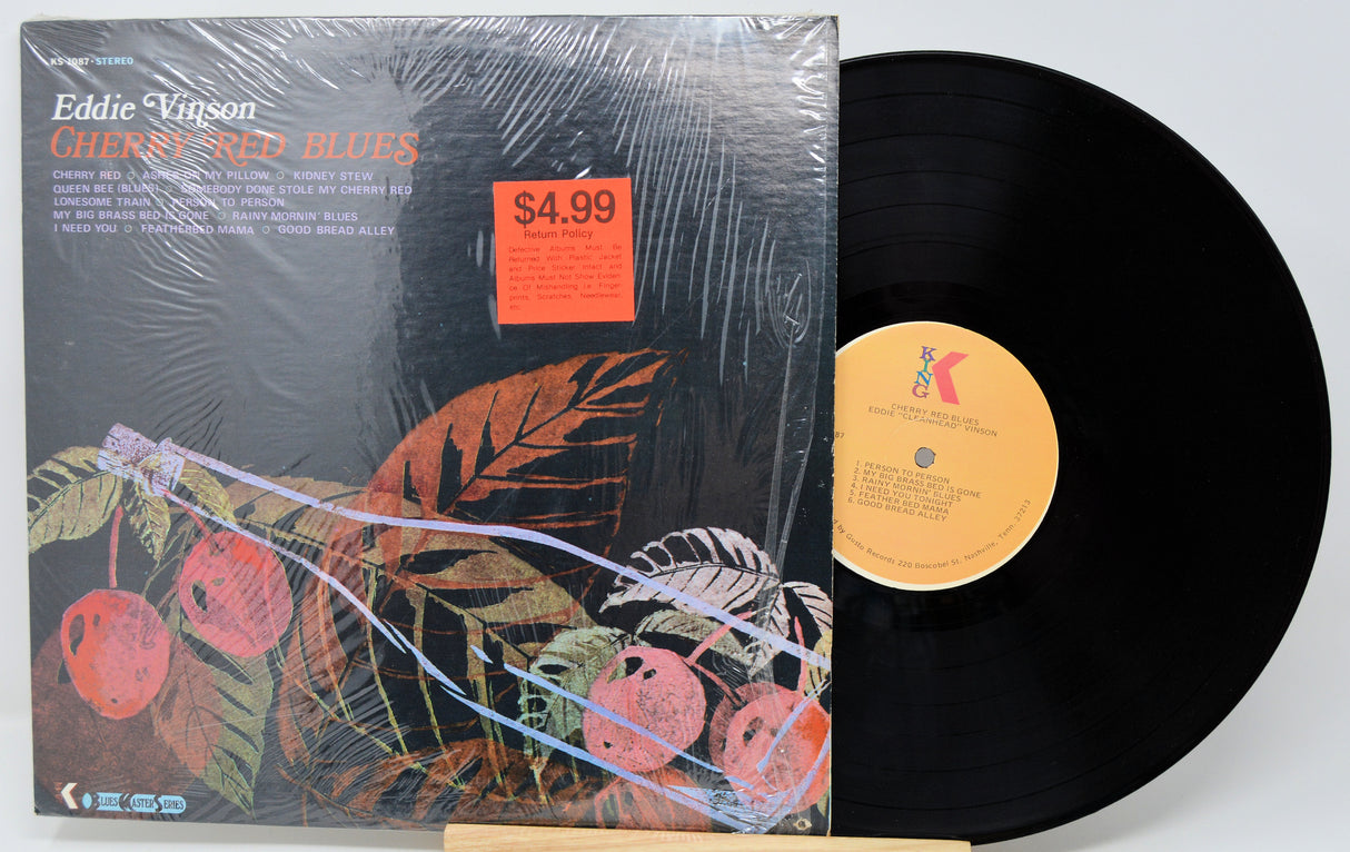 Vinyl record with cover featuring cherries and a price tag