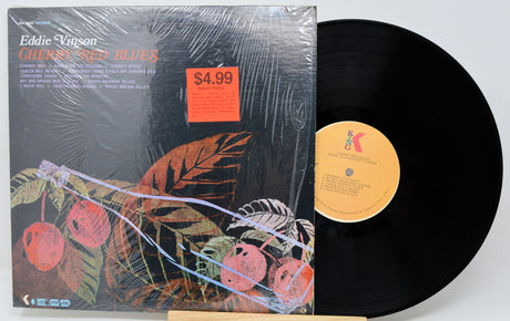 Vinyl record with cover featuring cherries and a price tag