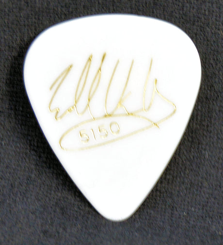 White guitar pick with gold Eddie Van Halen signature on a black background