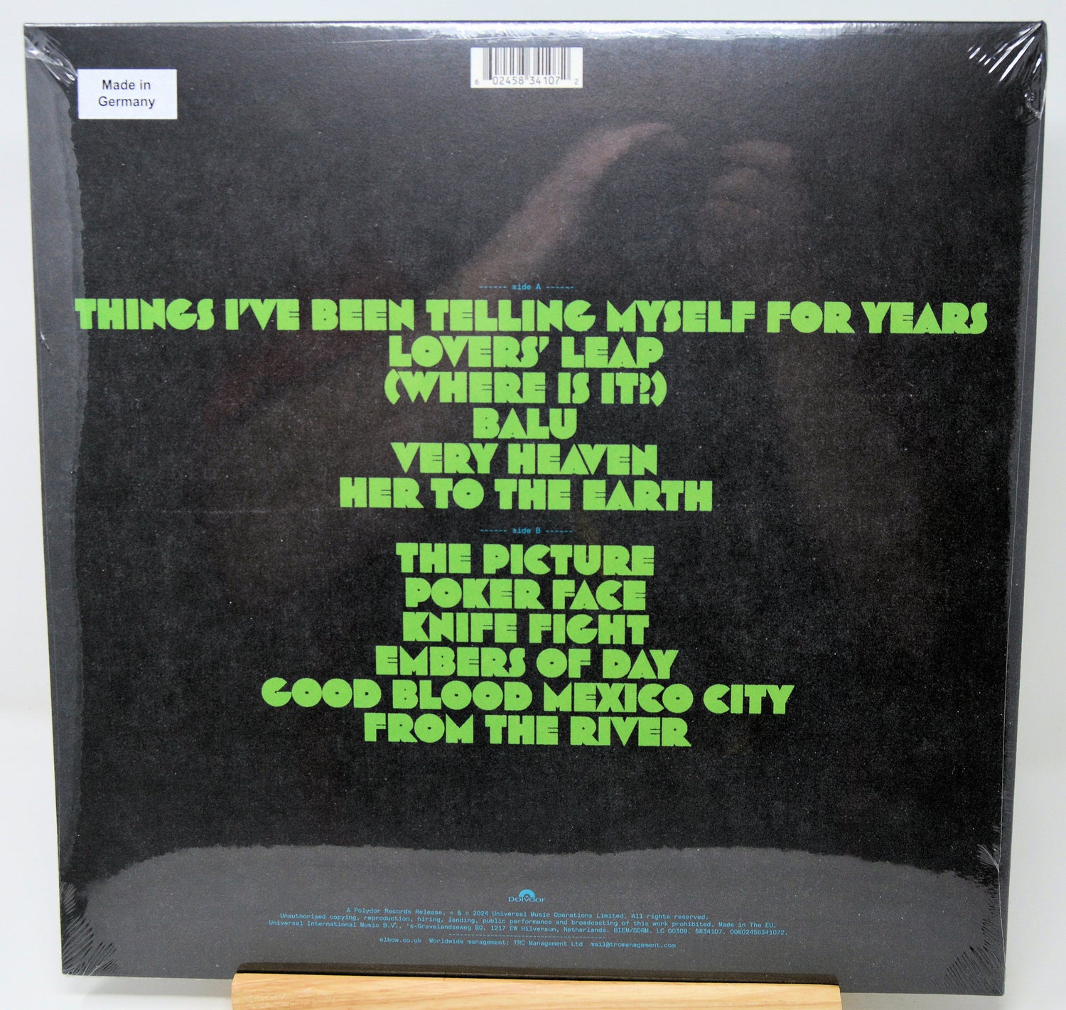 Vinyl record cover with green text on a black background