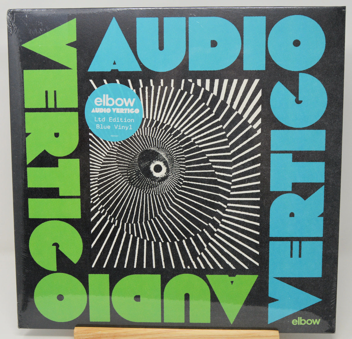 Vinyl record cover with 'Audio Vertigo' design and 'elbow' branding.
