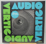 Vinyl record cover with 'Audio Vertigo' design and 'elbow' branding.