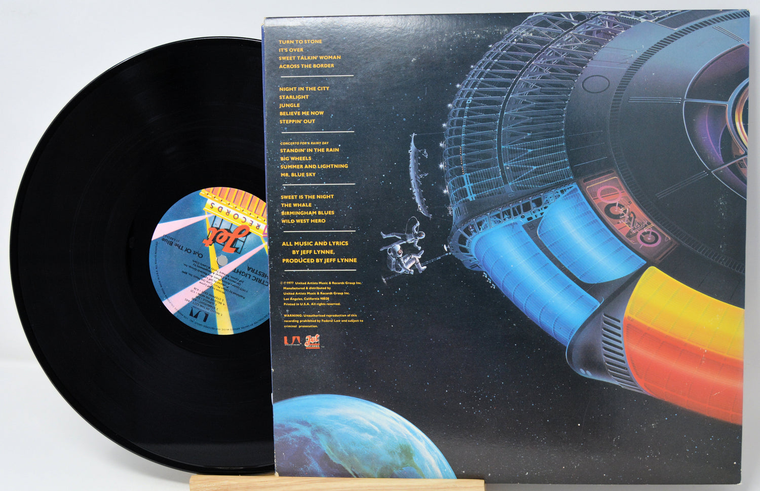 Vinyl record with a colorful space-themed cover and sleeve