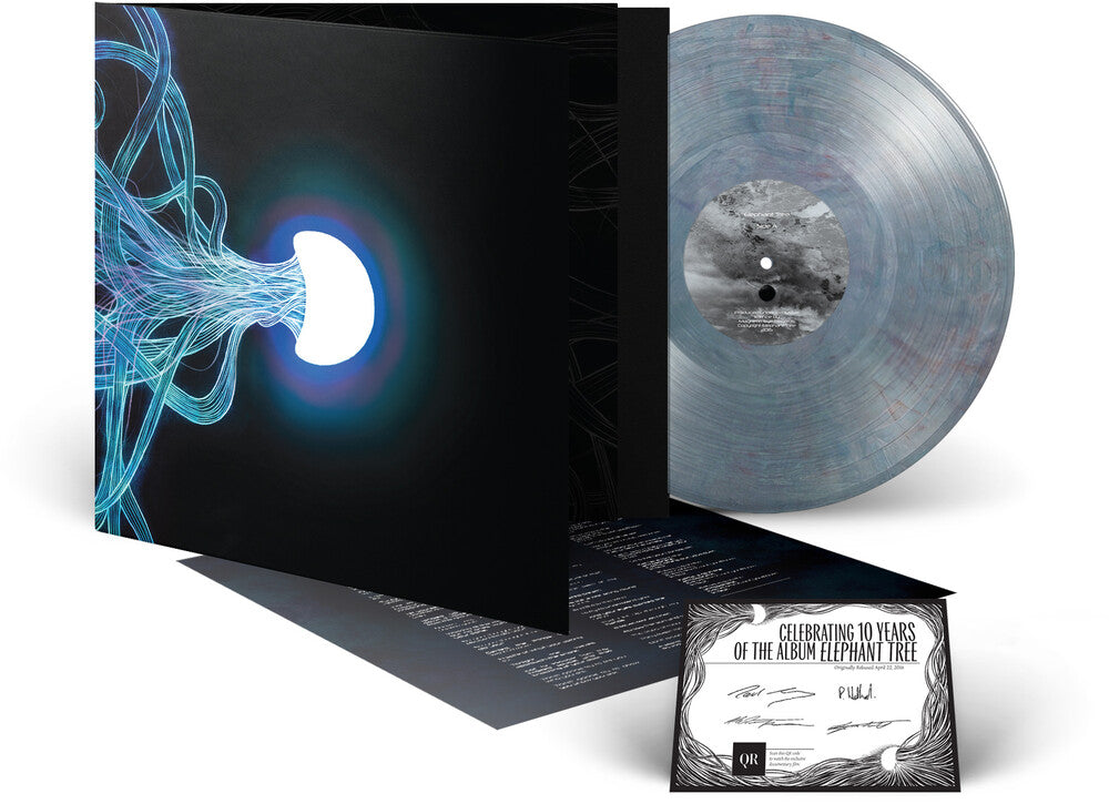 Vinyl record with a black cover featuring abstract design and a small certificate on a white background
