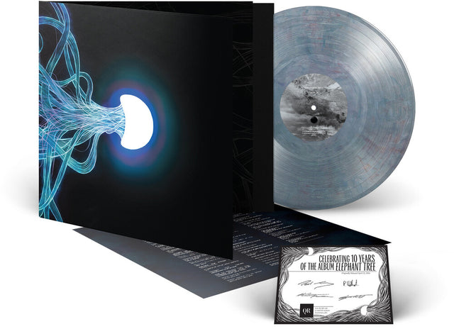 Vinyl record with a black cover featuring abstract design and a small certificate on a white background