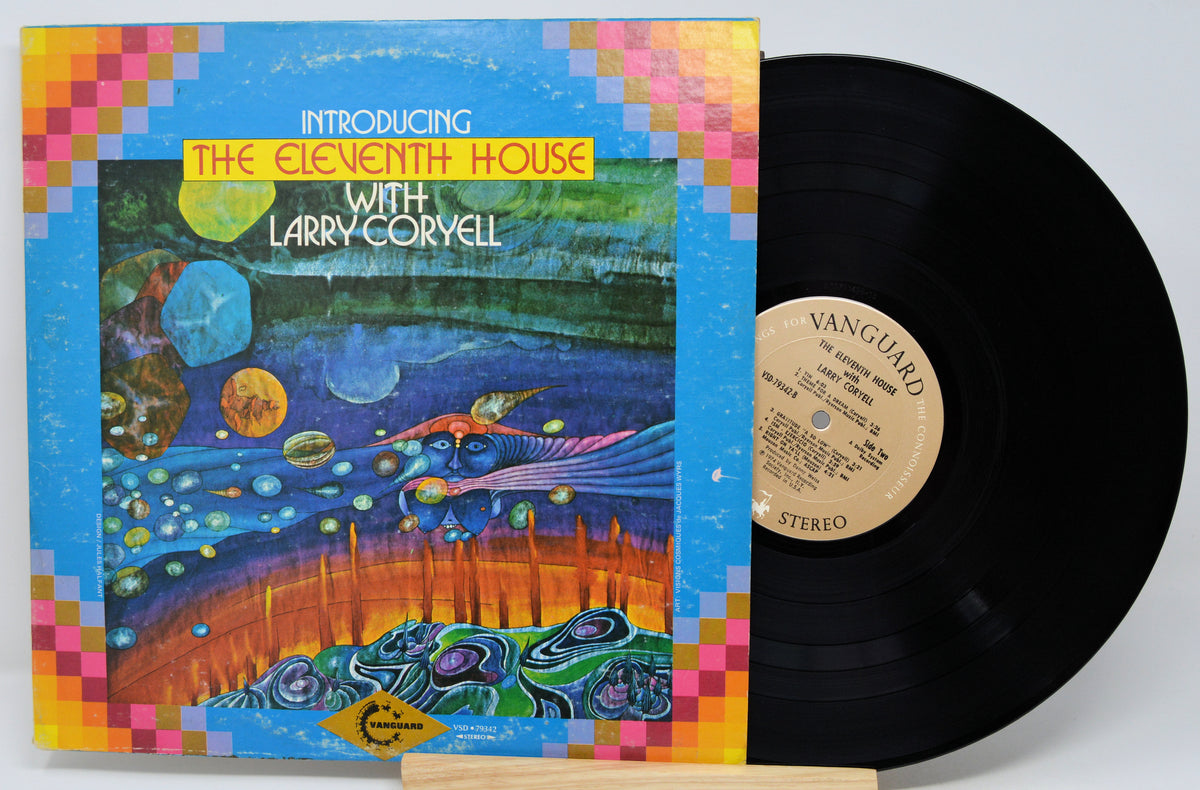 Vinyl record album for 'Introducing The Eleventh House With Larry Coryell' by The Eleventh House, shown with its illustrated cover and a black vinyl record partially pulled out. The record label reads Vanguard.