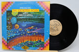 Vinyl record album for 'Introducing The Eleventh House With Larry Coryell' by The Eleventh House, shown with its illustrated cover and a black vinyl record partially pulled out. The record label reads Vanguard.