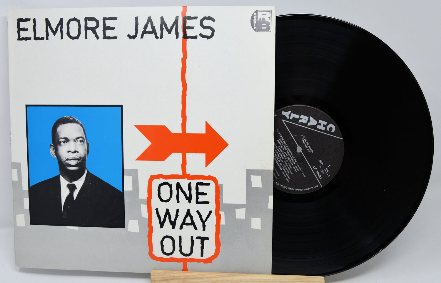 Vinyl record with 'Elmore James One Way Out' cover featuring a portrait and arrow design.