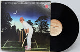 Vinyl record with cover featuring Elton John playing cricket, on a white background