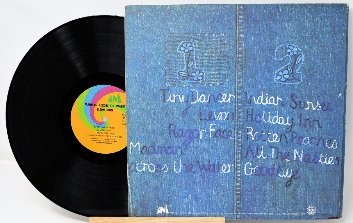 Vinyl record with a blue cover featuring text and a rainbow label.