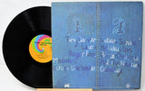 Vinyl record with a blue cover featuring text and a rainbow label.