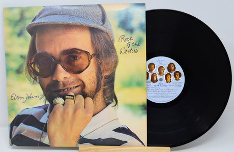 Vinyl record with cover featuring a man's face and album details