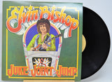 Vinyl record with a colorful cover featuring a person playing guitar, titled 'Juke Joint Jump' by Elvin Bishop.