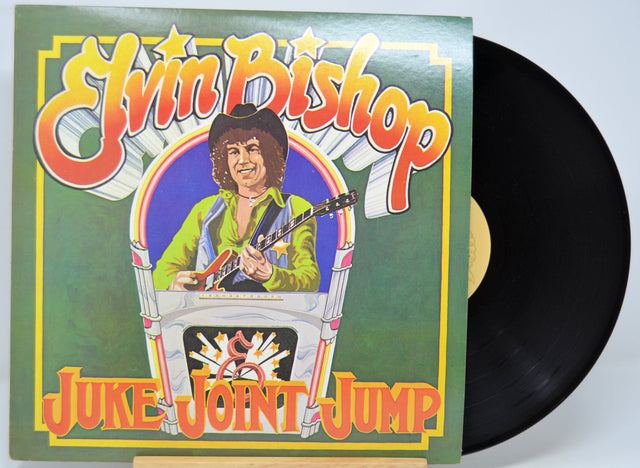 Vinyl record with a colorful cover featuring a person playing guitar, titled 'Juke Joint Jump' by Elvin Bishop.