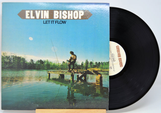 Vinyl record with cover featuring a person on a dock by a lake, titled 'Let It Flow' by Elvin Bishop.