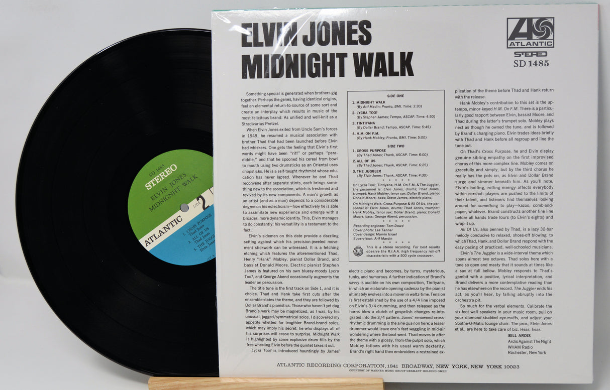 Elvis Jones - Midnight Walk vinyl record LP with the black record partially pulled from the white paper sleeve, showing the tracklist and Atlantic Records branding.