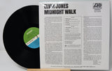 Elvis Jones - Midnight Walk vinyl record LP with the black record partially pulled from the white paper sleeve, showing the tracklist and Atlantic Records branding.