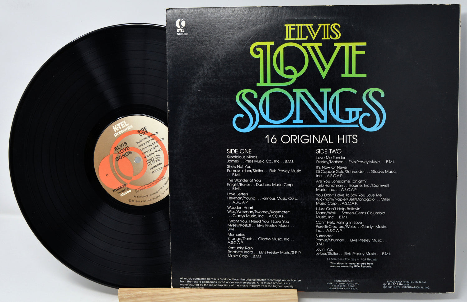 Vinyl record with 'Elvis Love Songs' album cover on a white background