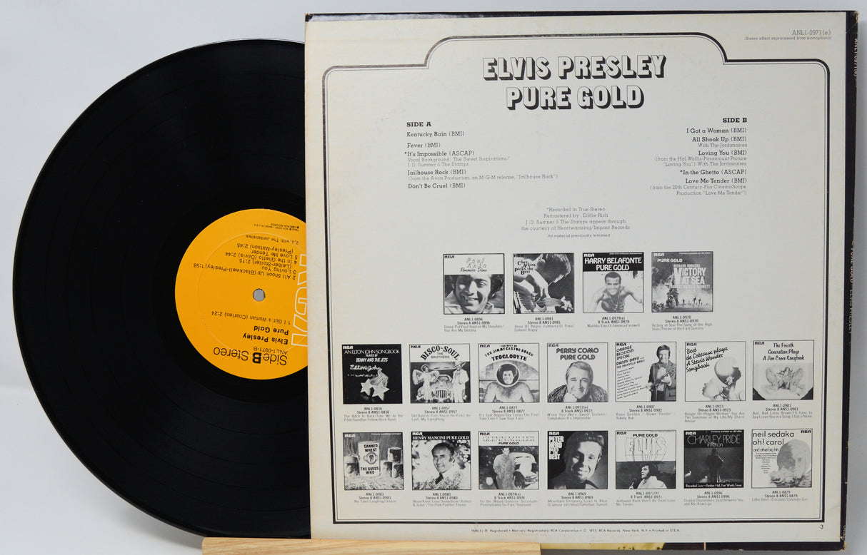 Vinyl record with 'Elvis Presley Pure Gold' cover showing black and white album design.
