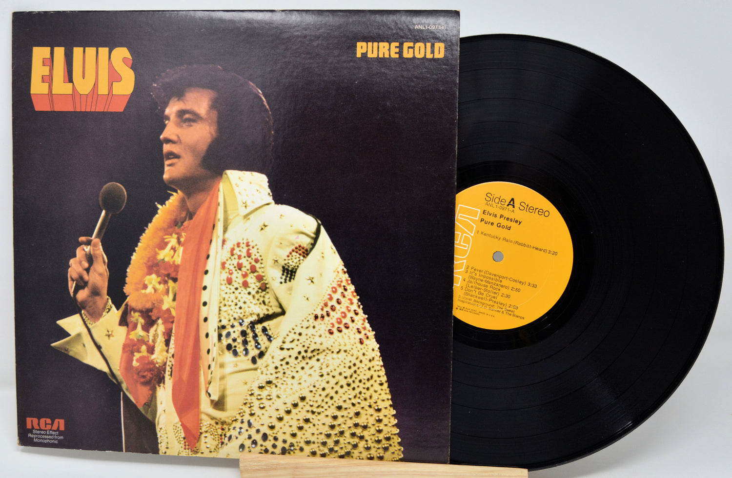 Vinyl record and cover featuring Elvis Presley with 'Pure Gold' text.